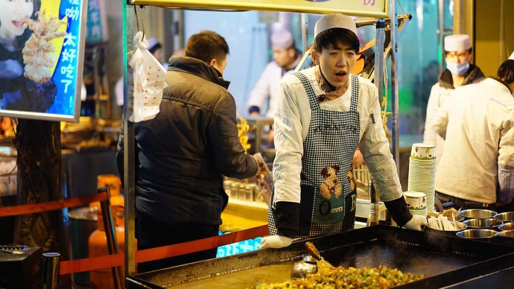 A busy street food market in China at night