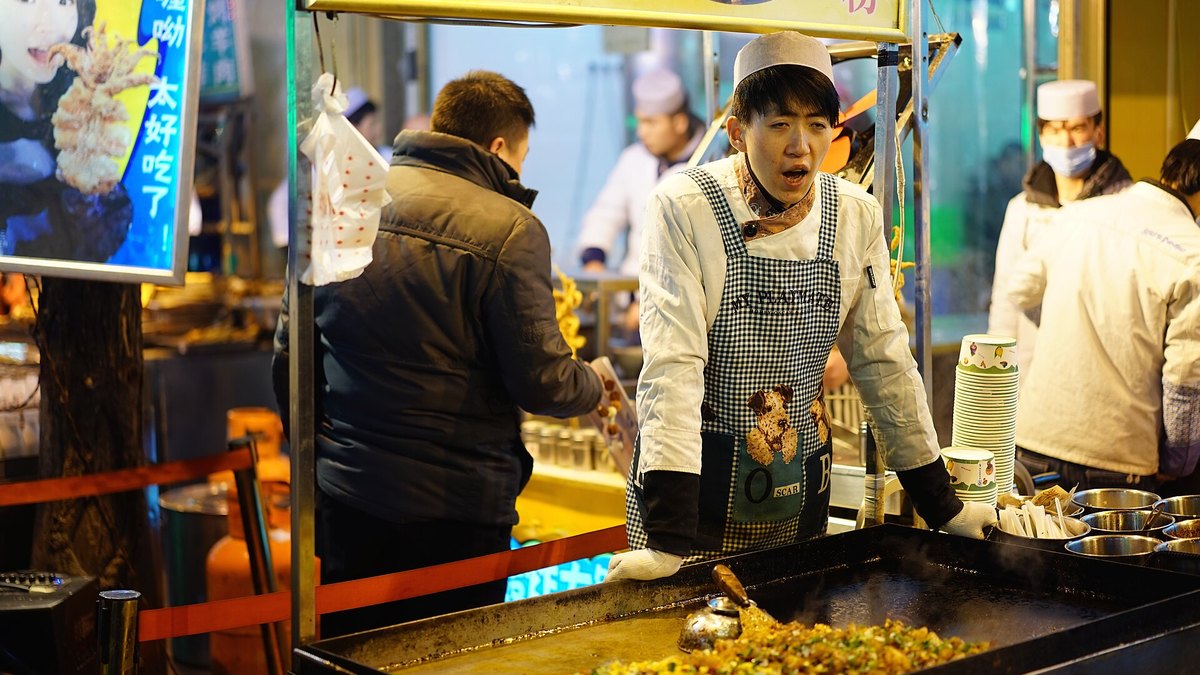 A busy street food market in China at night